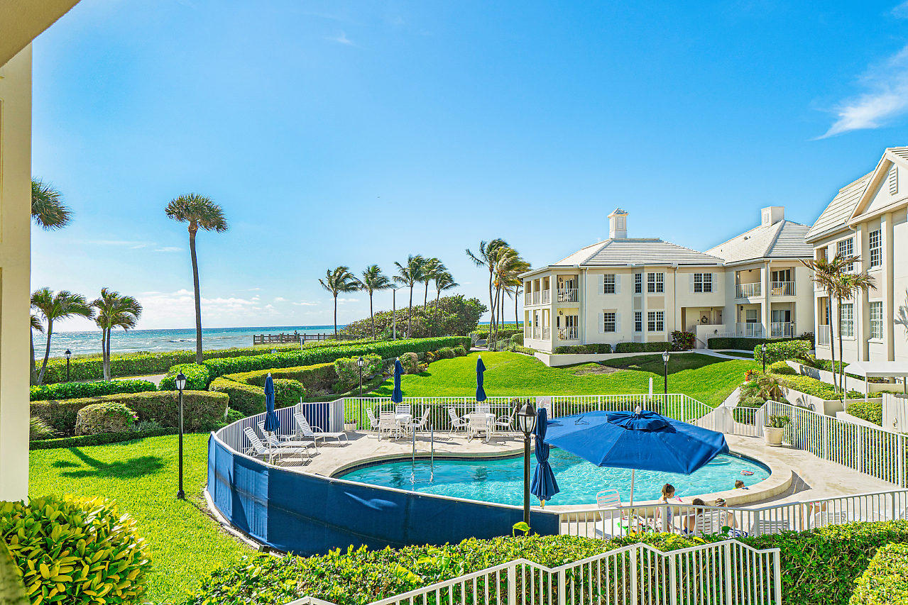 a view of a house with backyard porch and sitting area