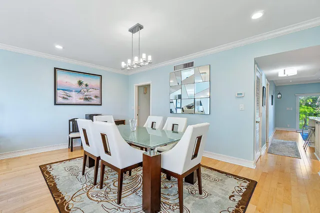 a view of a dining room with furniture wooden floor and a chandelier