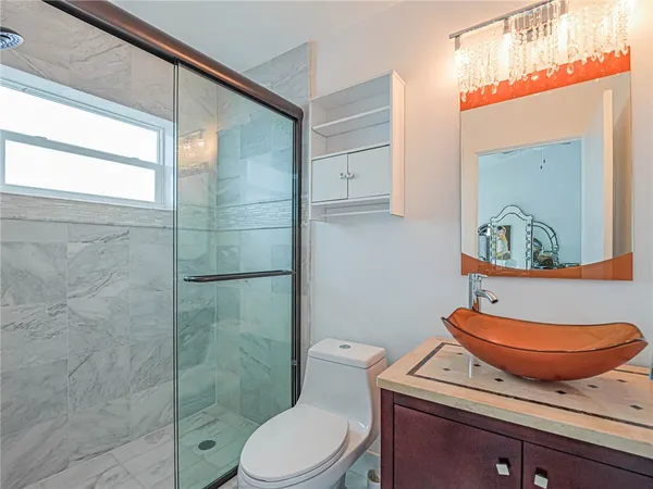 a bathroom with a toilet a sink and a shower
