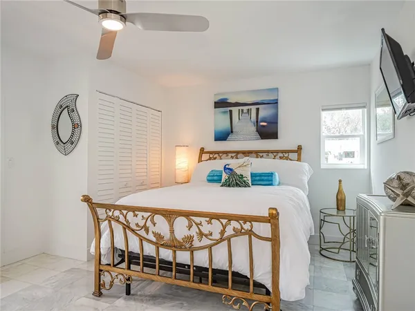 a bedroom with a bed a window and dresser