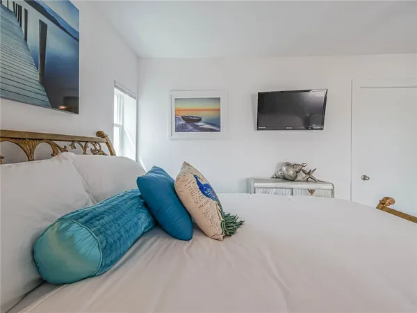 a bedroom with furniture and a flat screen tv