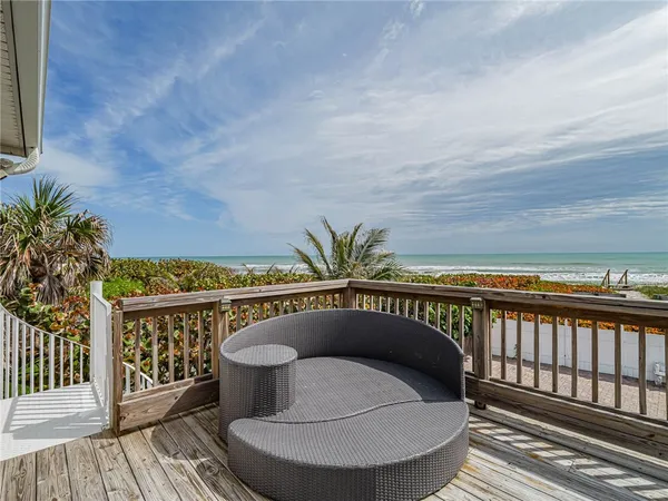 a balcony with table and chairs