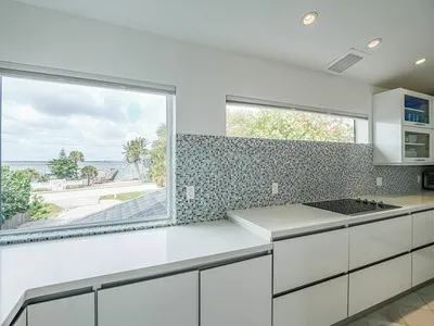 a kitchen with a sink and large window