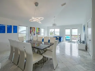 a view of a dining room with furniture and a chandelier