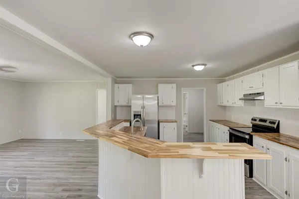 a view of kitchen with sink and wooden floor