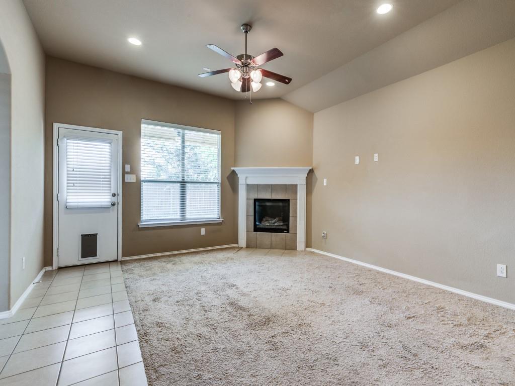 11608 Netleaf Lane Fort Worth, TX 76244 - Photo 3 of 12 a view of an empty room with a fireplace and a window