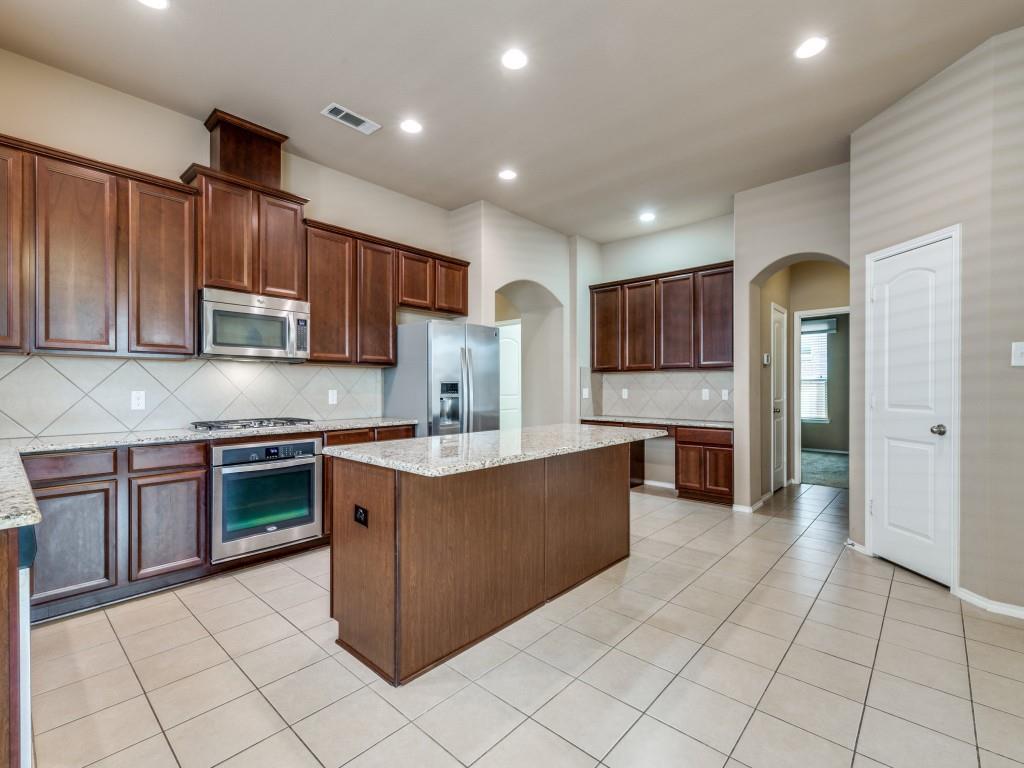 11608 Netleaf Lane Fort Worth, TX 76244 - Photo 6 of 12 a large kitchen with stainless steel appliances granite countertop a sink and cabinets
