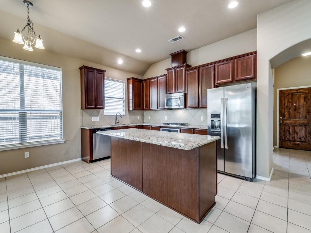 11608 Netleaf Lane Fort Worth, TX 76244 - Photo 7 of 12 a kitchen with stainless steel appliances granite countertop a refrigerator a sink a stove top oven and a refrigerator