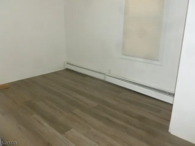 an empty room with wooden floor