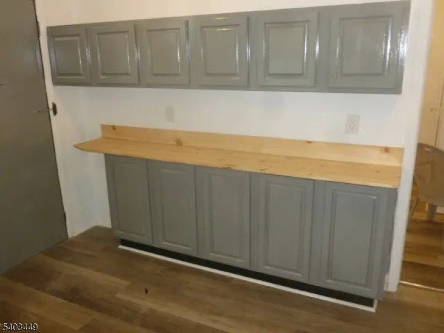 a view of storage and utility room with wooden floor