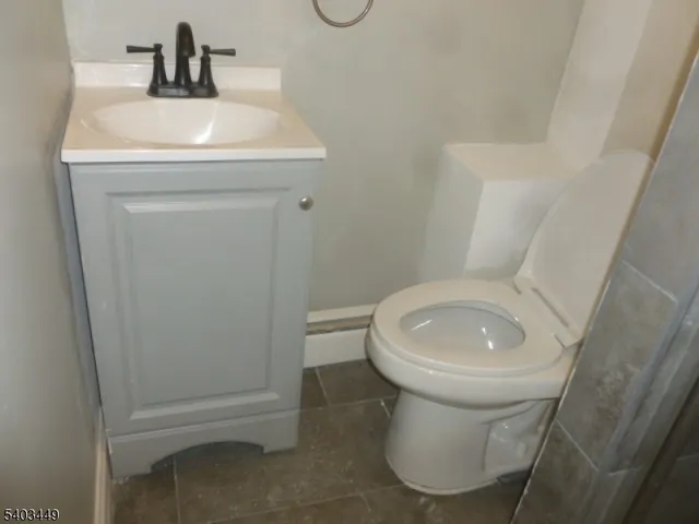 a bathroom with a sink toilet and a mirror