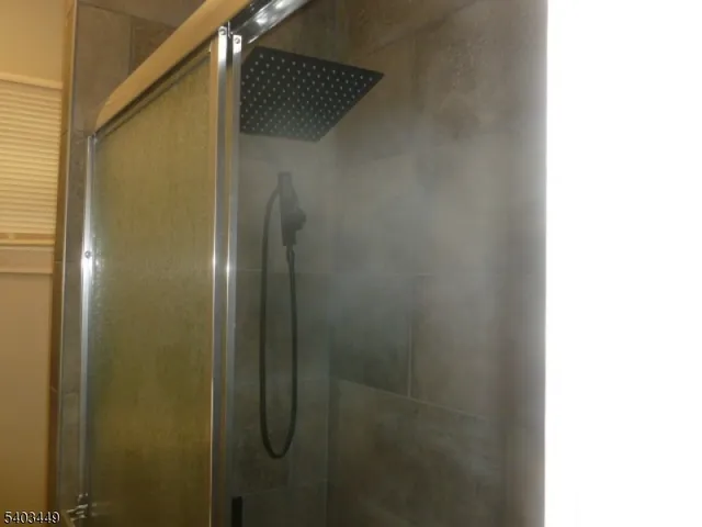 a bathroom with a glass shower door