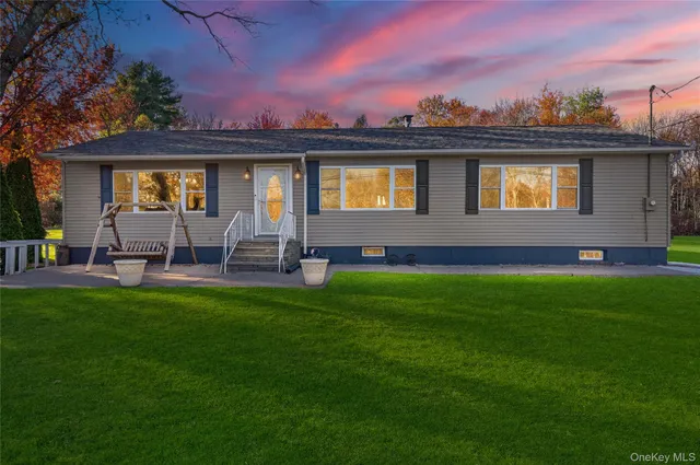 a front view of a house with a garden