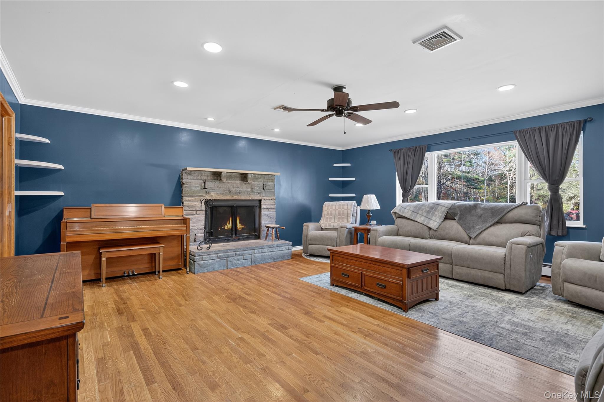 91 Meyerhoff Road Hurleyville, NY 12747 - Photo 11 of 43 a living room with furniture a fireplace and a flat screen tv