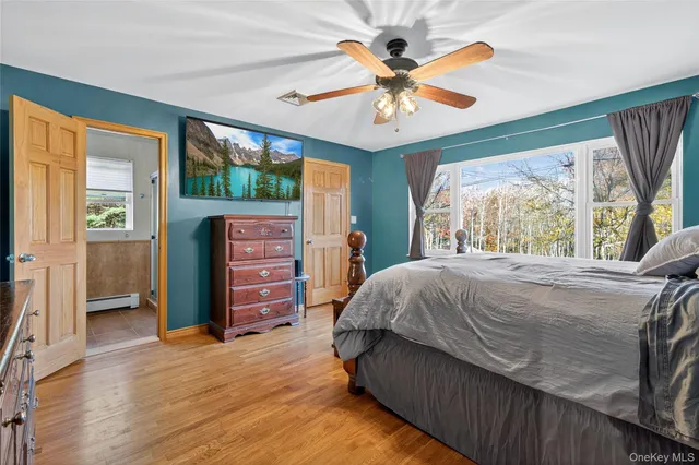 a bed sitting in a spacious bedroom next to a window