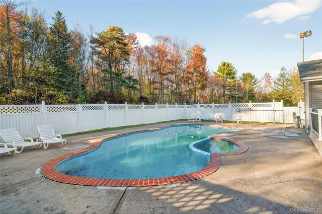 a view of a swimming pool with an outdoor space and seating area