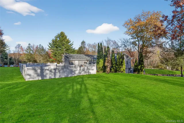 a view of a park with a house in the background