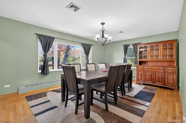 a view of a dining room with furniture window and wooden floor