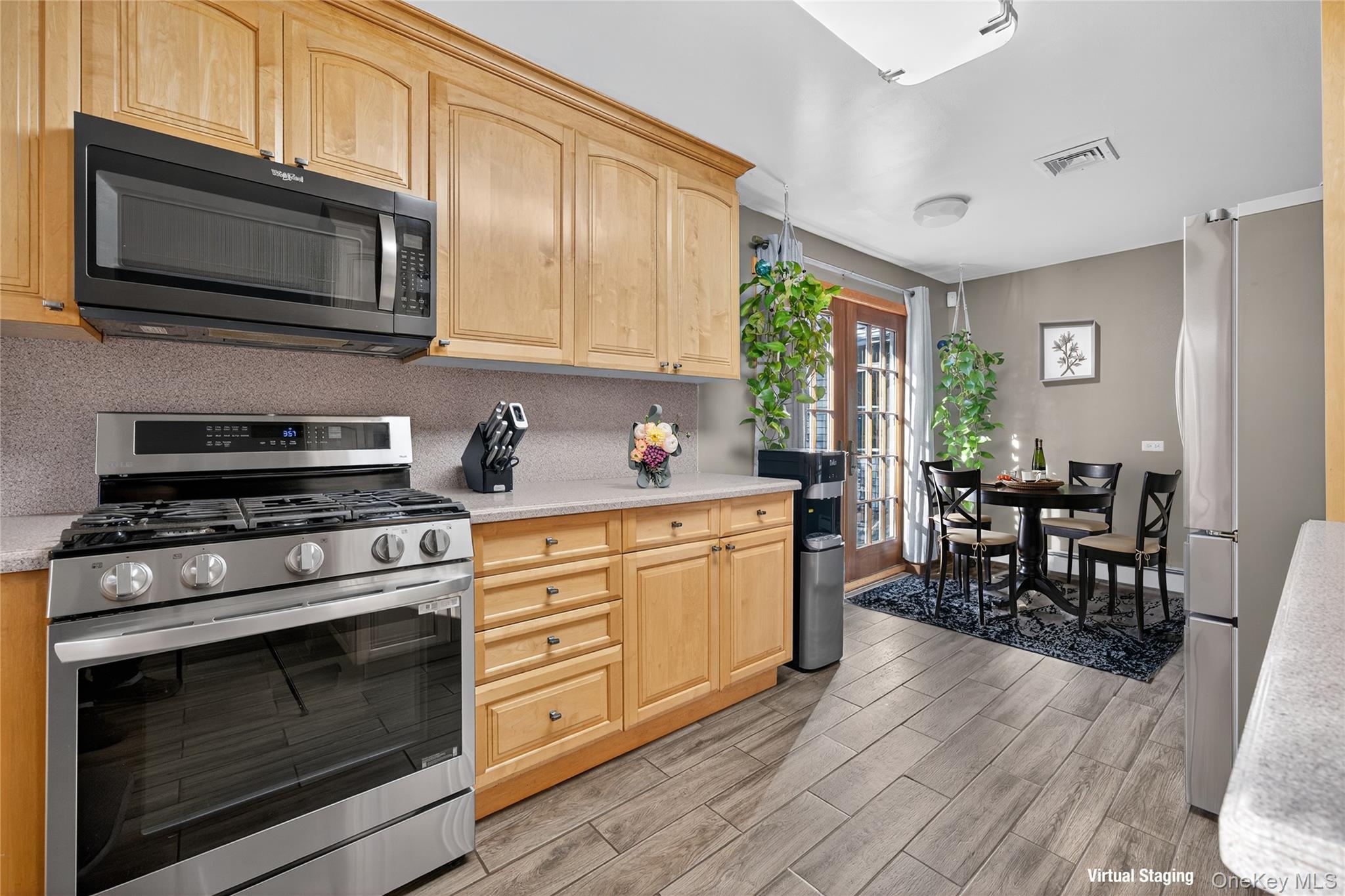 91 Meyerhoff Road Hurleyville, NY 12747 - Photo 8 of 43 a kitchen with stainless steel appliances a stove a sink cabinets and a wooden floor