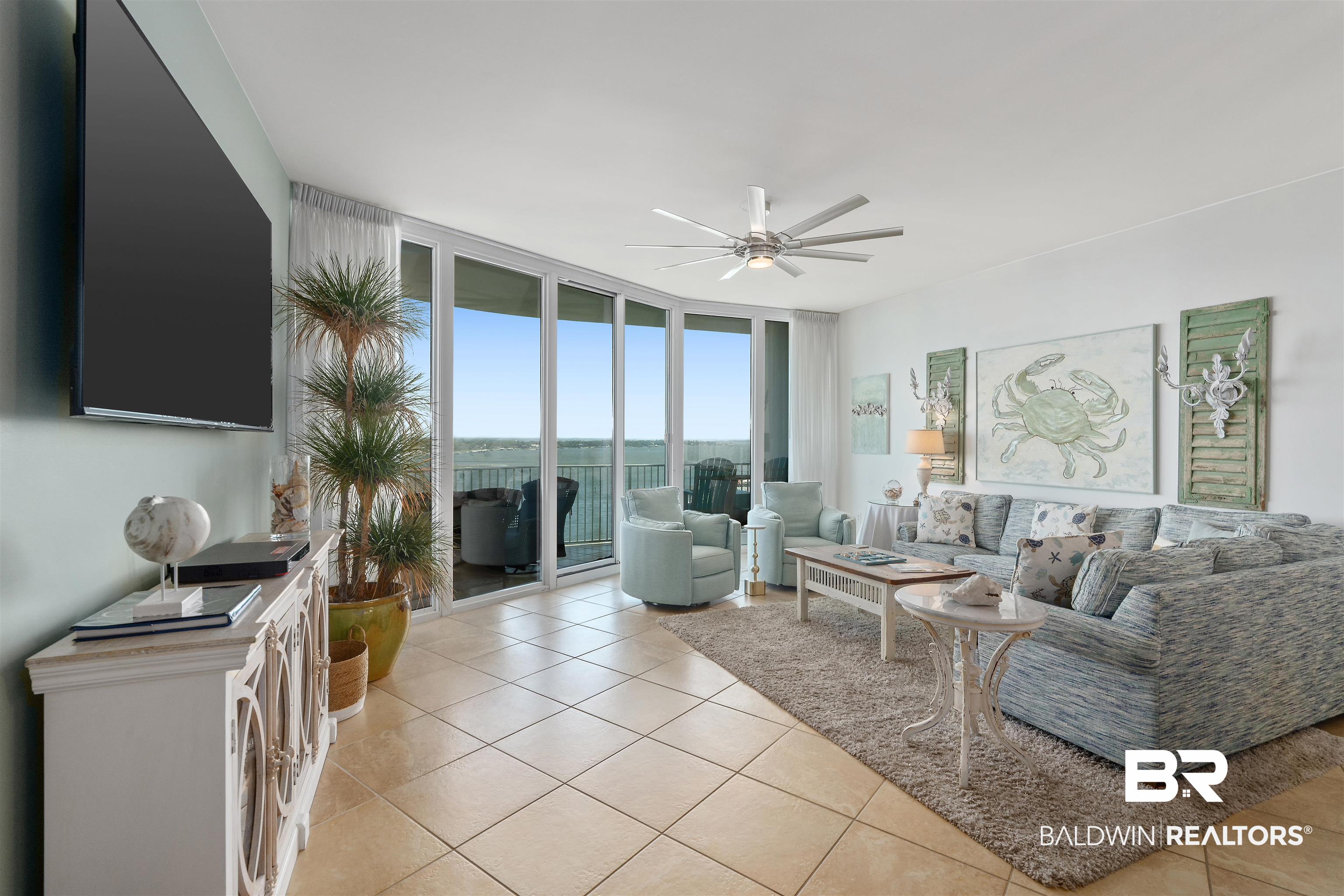 28107 Perdido Beach Boulevard, Unit DPH06 Orange Beach, AL 36561 - Photo 4 of 70 Living room with a wall of windows, ceiling fan, and light tile patterned flooring