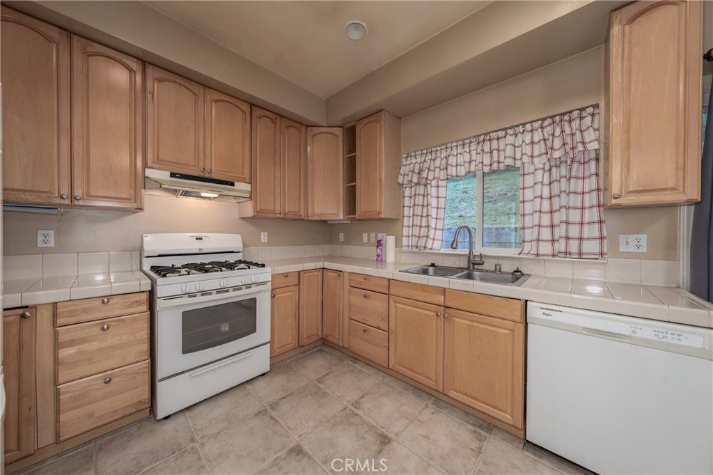 10401 Point Lakeview Road Kelseyville, CA 95451 - Photo 19 of 41 a kitchen with a sink stove and cabinets