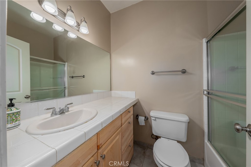10401 Point Lakeview Road Kelseyville, CA 95451 - Photo 27 of 41 a bathroom with a sink toilet and a mirror