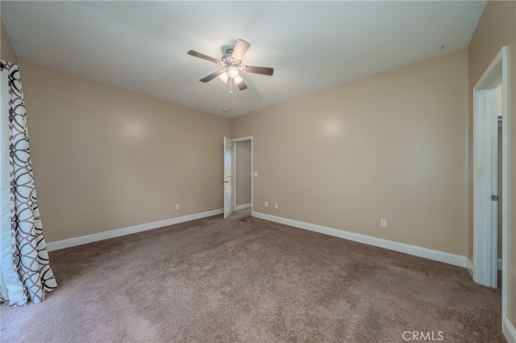 10401 Point Lakeview Road Kelseyville, CA 95451 - Photo 29 of 41 an empty room with windows and fan