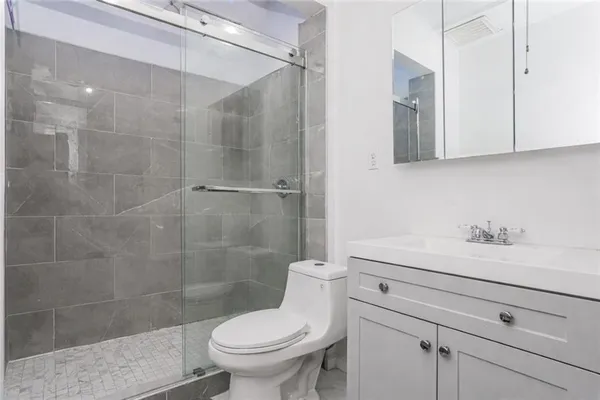 a bathroom with a sink a toilet and a shower