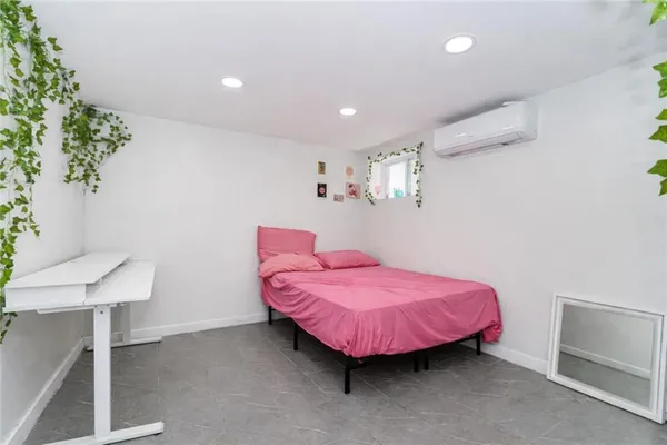 a spacious bedroom with a bed and a table chair