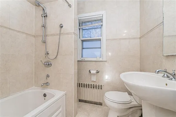 a bathroom with a bathtub toilet and sink