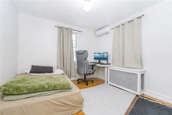 a bedroom with a bed a table and chair