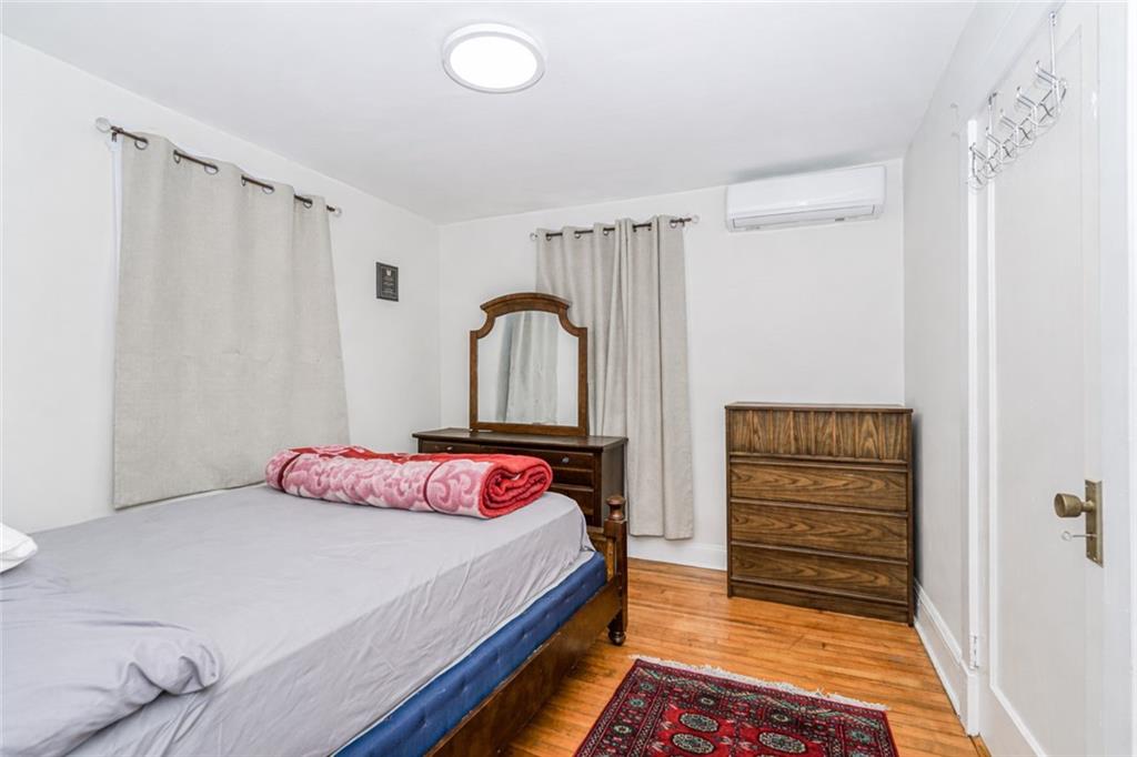 119 Watchogue Road Staten Island, NY 10314 - Photo 16 of 26 a bedroom with a bed and a dresser