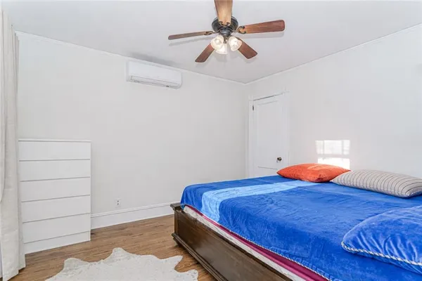 a bedroom with a bed and a ceiling fan