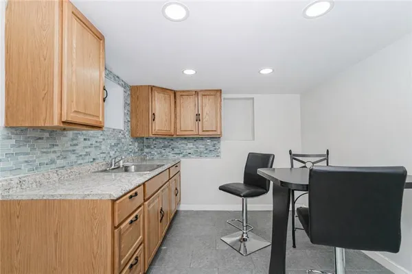 a kitchen with granite countertop sink cabinets and chairs