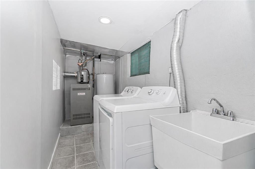 119 Watchogue Road Staten Island, NY 10314 - Photo 23 of 26 a utility room with dryer and washer