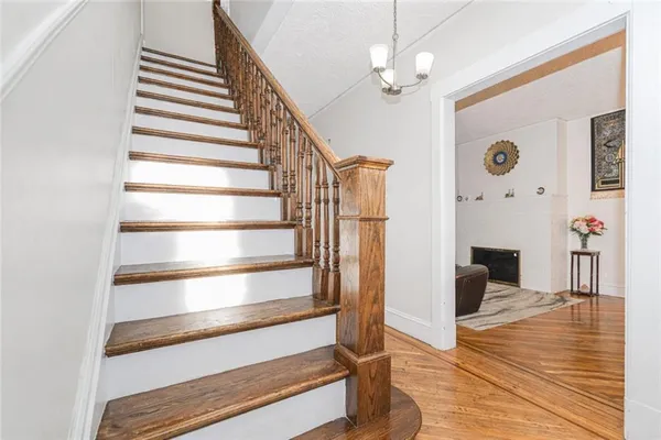 a view of an entryway with wooden floor and a front door