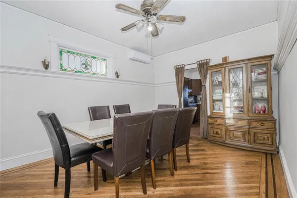 a view of a dining room with furniture wooden floor and chandelier
