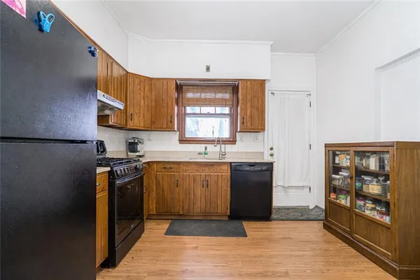 a kitchen with stainless steel appliances granite countertop a refrigerator sink and stove