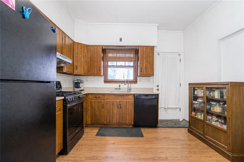 119 Watchogue Road Staten Island, NY 10314 - Photo 10 of 26 a kitchen with stainless steel appliances granite countertop a refrigerator sink and stove
