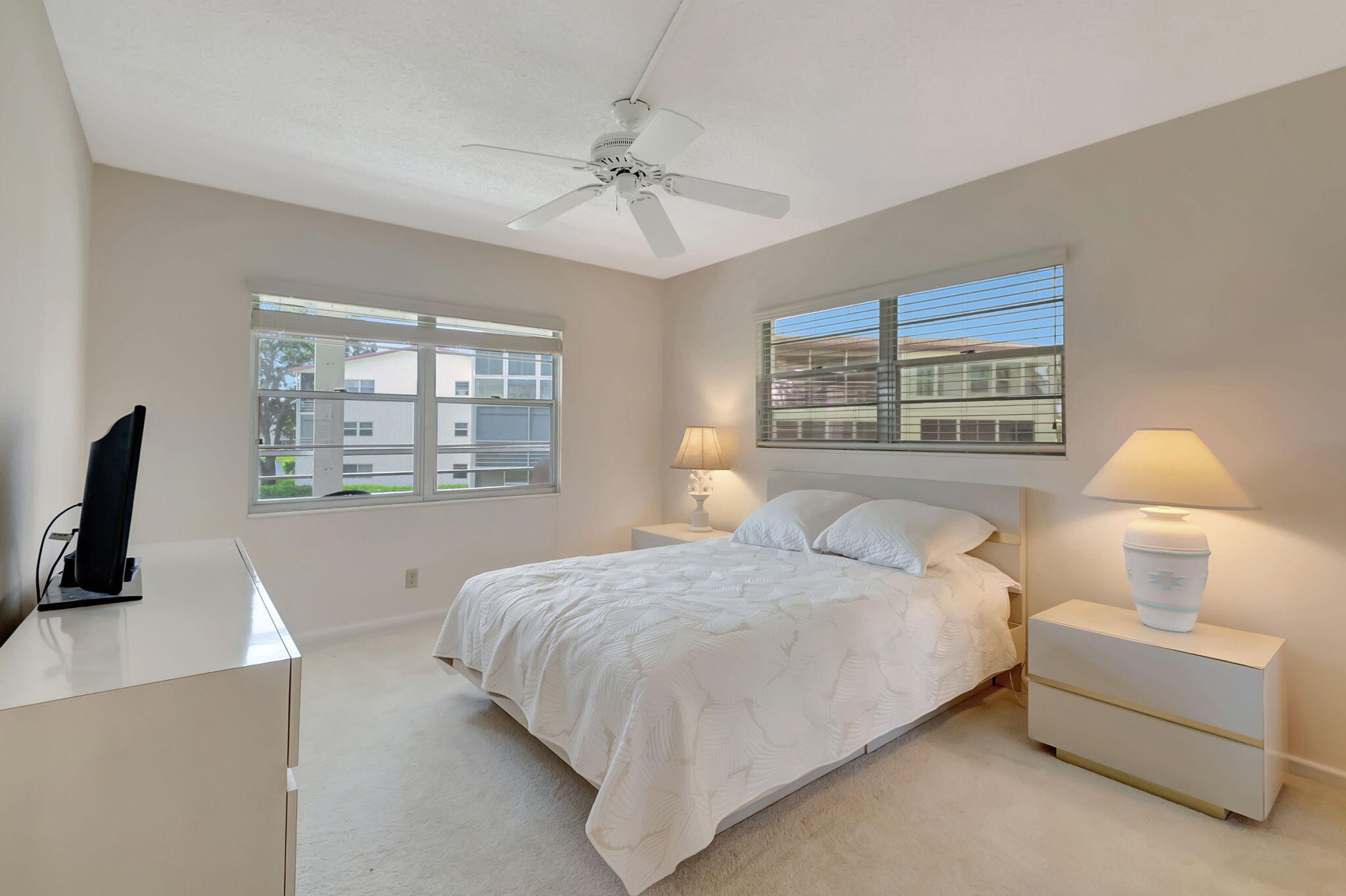 28 Fanshaw A Boca Raton, FL 33434 - Photo 14 of 63 a bedroom with a bed and a flat tv screen on the dresser
