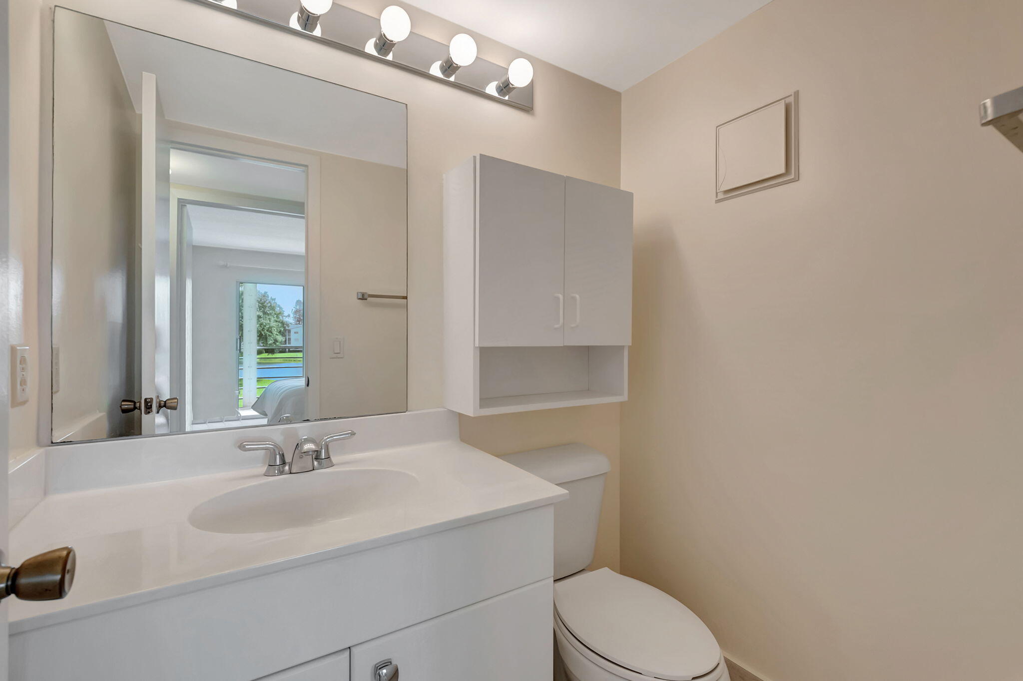 28 Fanshaw A Boca Raton, FL 33434 - Photo 16 of 63 a bathroom with a sink toilet vanity and mirror