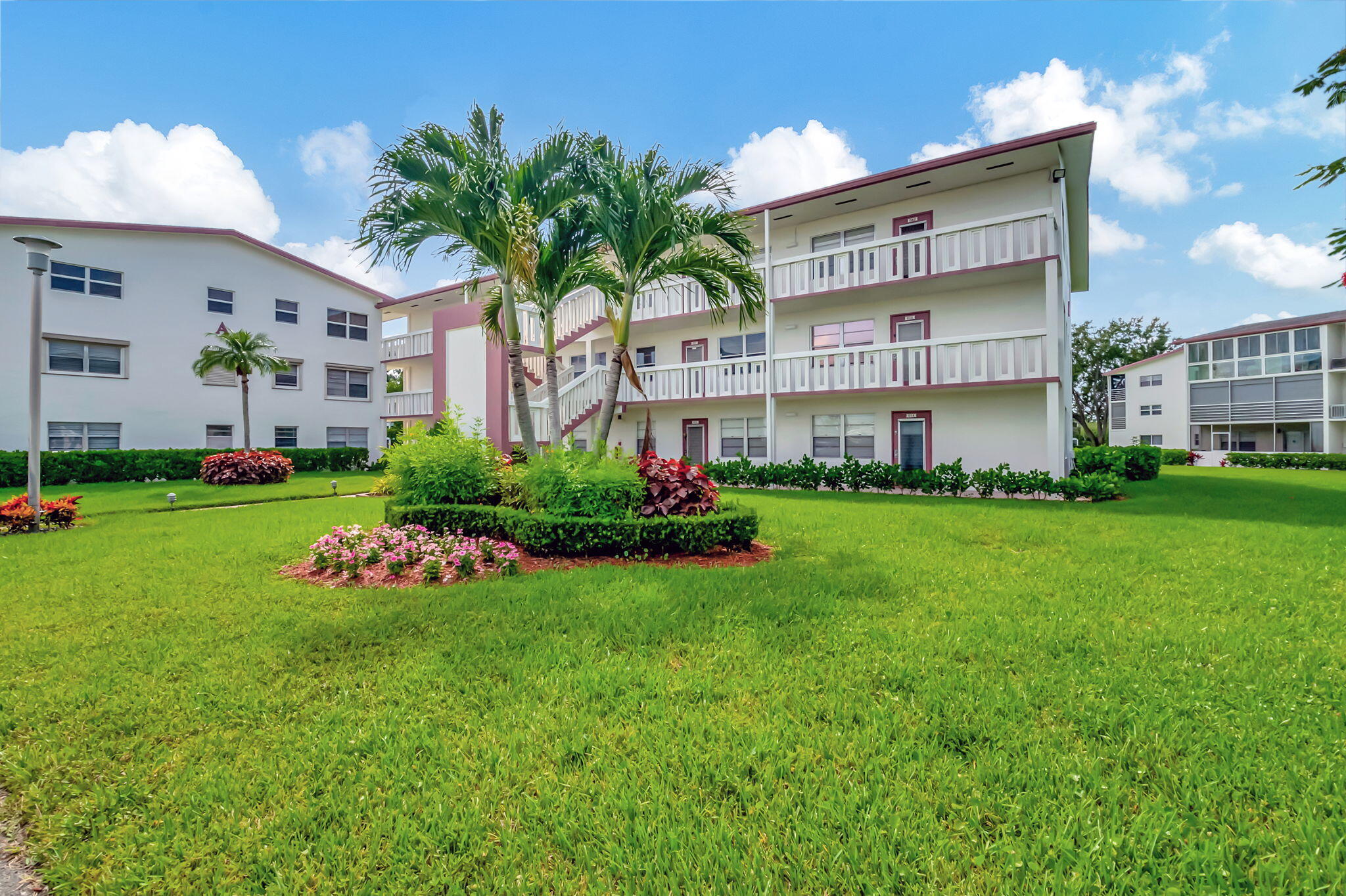 28 Fanshaw A Boca Raton, FL 33434 - Photo 22 of 63 a front view of a house with a garden and trees