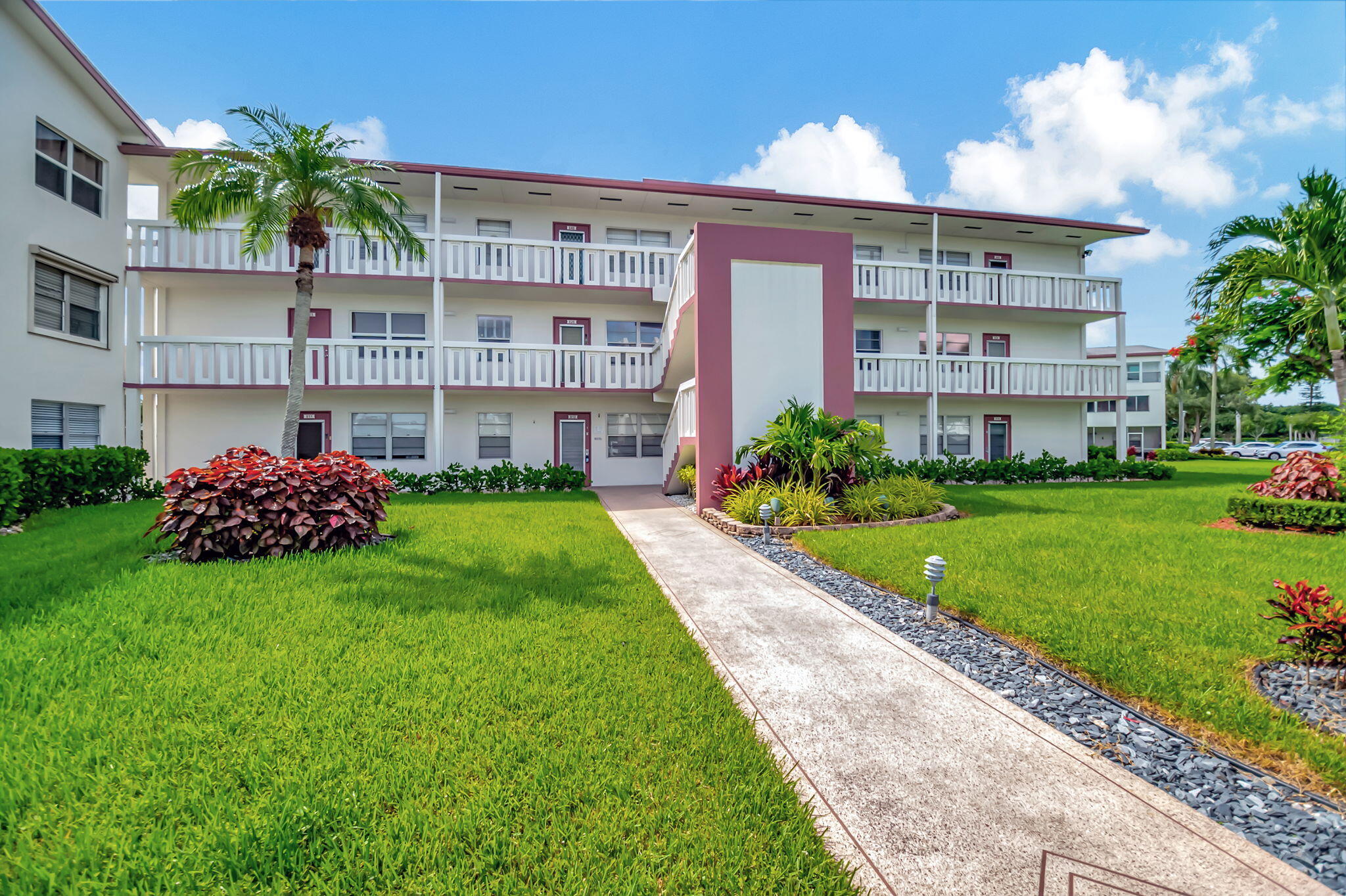 28 Fanshaw A Boca Raton, FL 33434 - Photo 24 of 63 a front view of a building with a garden
