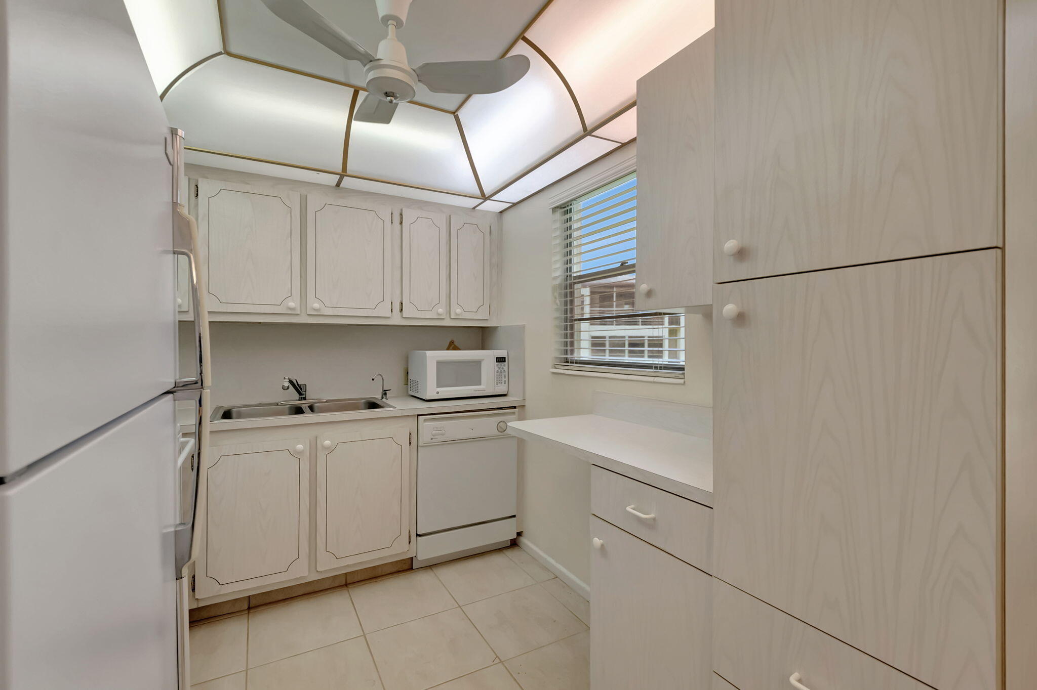 28 Fanshaw A Boca Raton, FL 33434 - Photo 6 of 63 a kitchen with stainless steel appliances a refrigerator and white cabinets