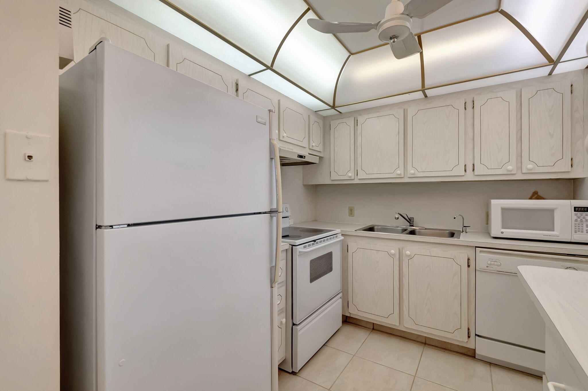 28 Fanshaw A Boca Raton, FL 33434 - Photo 7 of 63 a white refrigerator freezer sitting inside of a kitchen