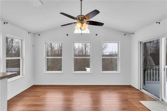 a view of an empty room with wooden floor