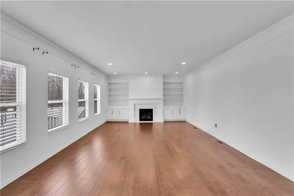 wooden floor in an empty room with a fireplace