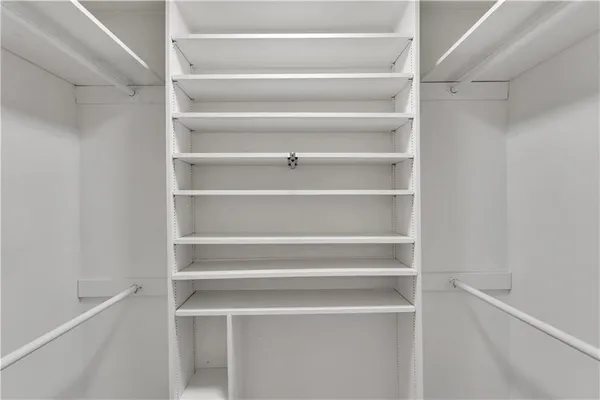 a bathroom with a granite countertop toilet sink and mirror
