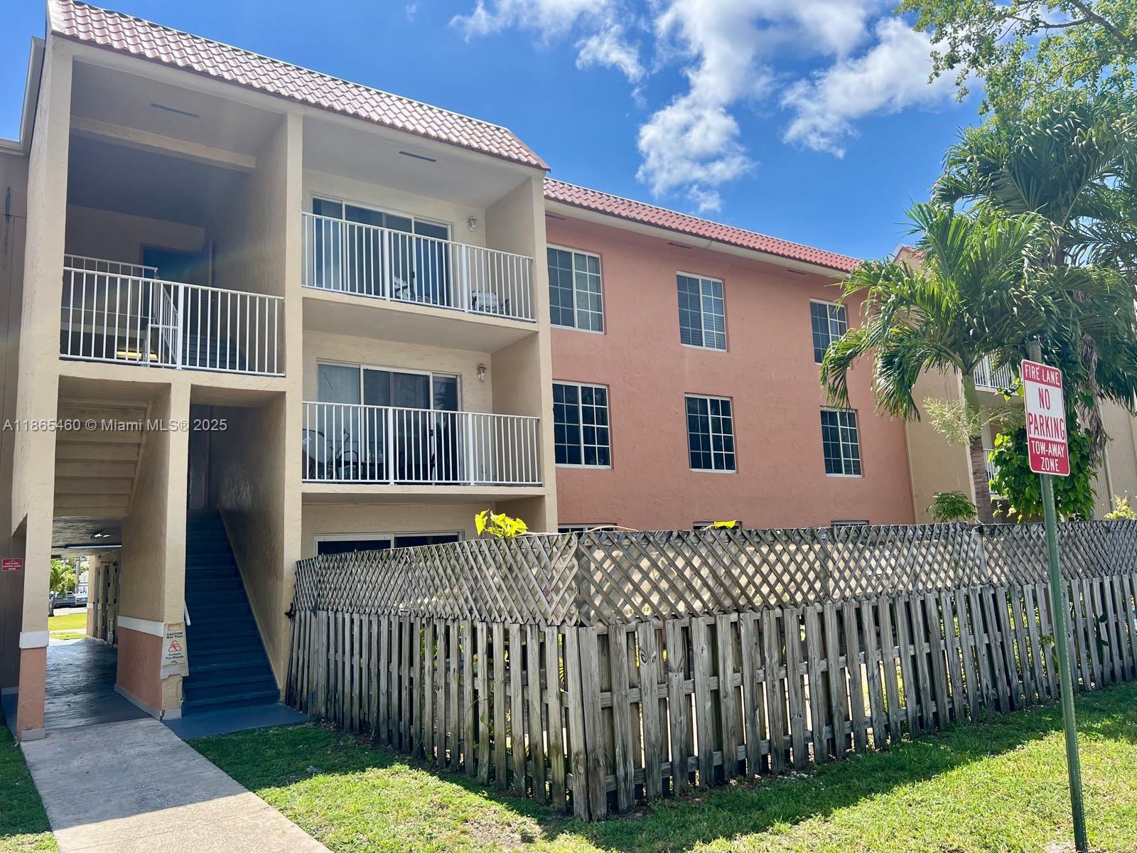 4810 Northwest 79th Avenue, Unit 305 Doral, FL 33166 - Photo 16 of 28 a front view of a house with a garden
