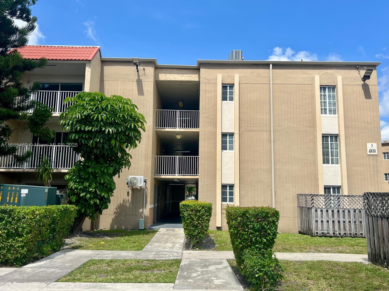 4810 Northwest 79th Avenue, Unit 305 Doral, FL 33166 - Photo 18 of 28 a front view of a house with a yard